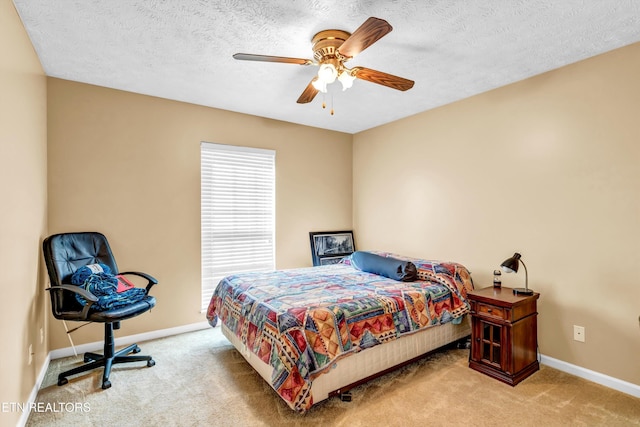 bedroom featuring baseboards, a ceiling fan, carpet flooring, and a textured ceiling