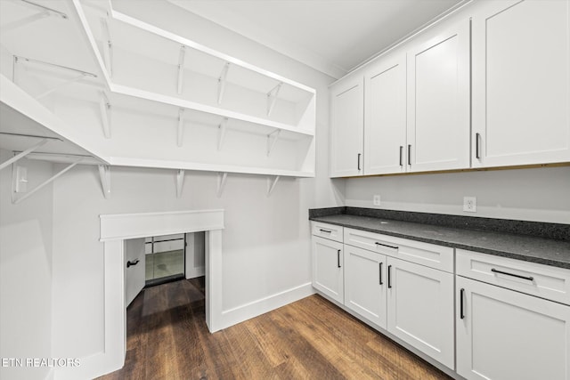 washroom featuring dark wood-style floors and baseboards