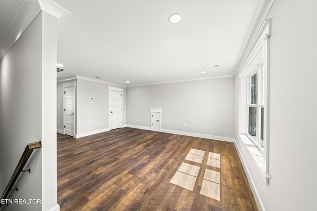 unfurnished living room with dark wood-style flooring, ornamental molding, baseboards, and recessed lighting