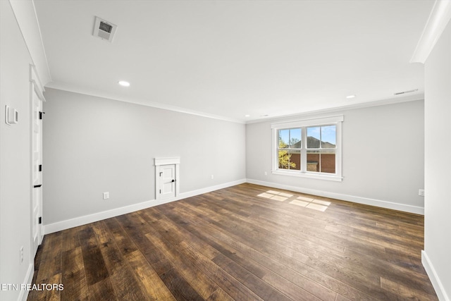 unfurnished room featuring dark wood-type flooring, visible vents, baseboards, and ornamental molding