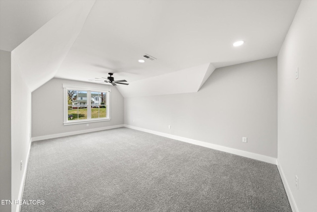 bonus room with visible vents, baseboards, vaulted ceiling, and carpet floors
