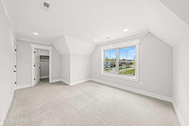 bonus room featuring visible vents, baseboards, and light colored carpet