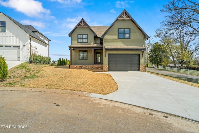 craftsman-style house with concrete driveway, an attached garage, brick siding, fence, and a shingled roof
