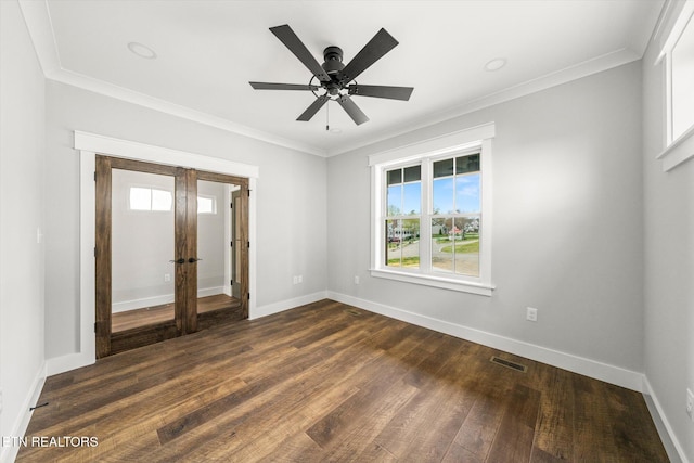 empty room featuring baseboards, french doors, dark wood-style flooring, and visible vents