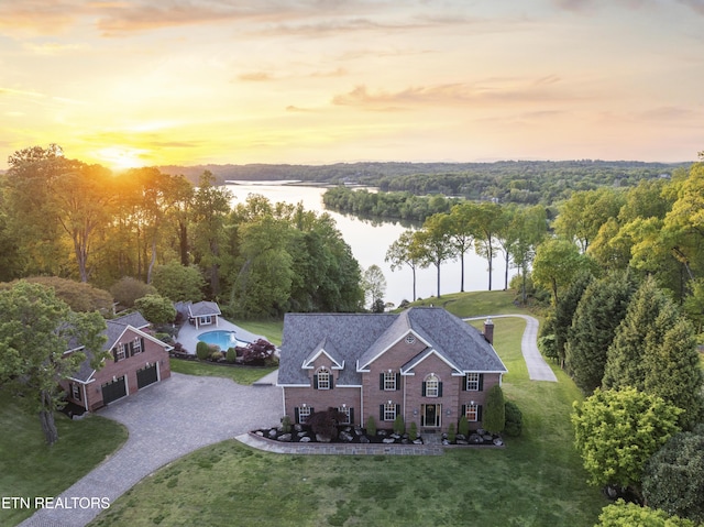 aerial view at dusk with a water view