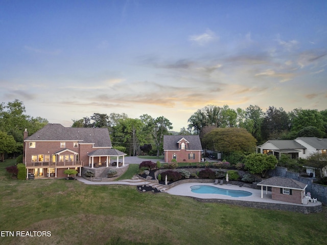 pool featuring a gazebo, a yard, and an outbuilding