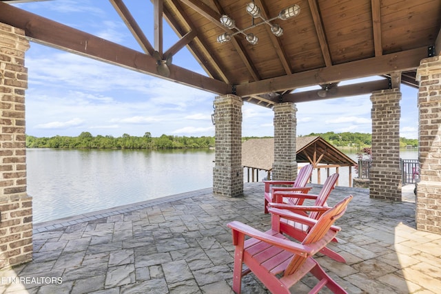view of patio with a gazebo and a water view