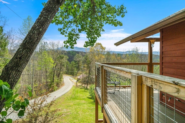 view of yard featuring a forest view and a mountain view