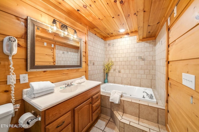 full bathroom with vanity, a relaxing tiled tub, wooden ceiling, and toilet