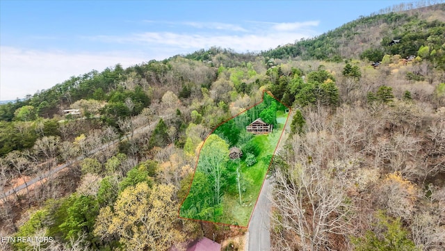 birds eye view of property with a wooded view