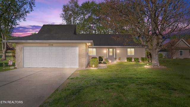 3576 E Atherton Ln, Baneberry, TN 37890 - view of front facade featuring driveway, stucco siding, an attached garage, and a lawn