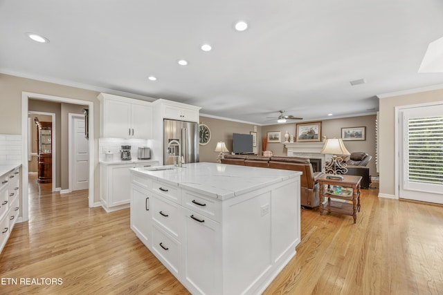 1647 Banebury Ln, Alcoa, TN 37701 - kitchen with high end refrigerator, a ceiling fan, open floor plan, ornamental molding, and a center island with sink