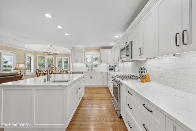 1647 Banebury Ln, Alcoa, TN 37701 - kitchen with appliances with stainless steel finishes, white cabinets, a chandelier, light stone countertops, and recessed lighting