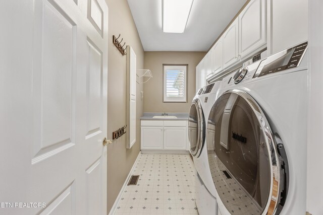 1647 Banebury Ln, Alcoa, TN 37701 - laundry area featuring washing machine and dryer, cabinet space, and light floors