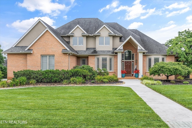 1647 Banebury Ln, Alcoa, TN 37701 - view of front of property featuring brick siding, a front lawn, stucco siding, and a shingled roof