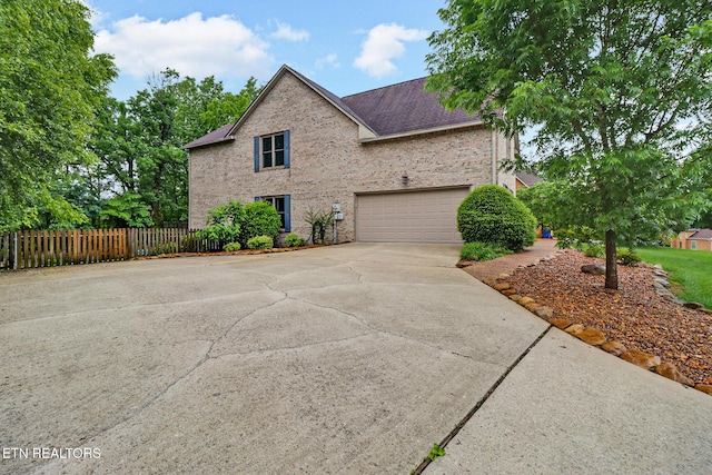 105 W Melbourne Rd, Oak Ridge, TN 37830 - view of side of property featuring driveway, brick siding, and roof with shingles