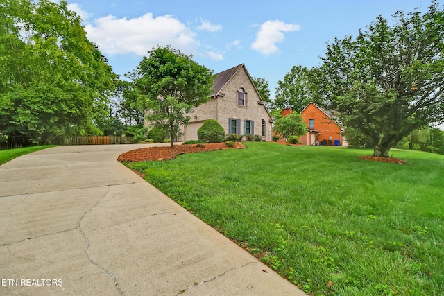 105 W Melbourne Rd, Oak Ridge, TN 37830 - view of front of house with driveway, a front yard, brick siding, and a garage