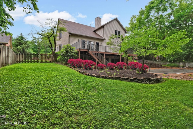 105 W Melbourne Rd, Oak Ridge, TN 37830 - back of property with stairs, a wooden deck, a chimney, and roof with shingles
