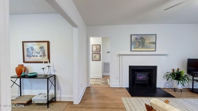 122 Lake View Dr, Knoxville, TN 37920 - living area featuring a fireplace with flush hearth, baseboards, visible vents, and wood finished floors