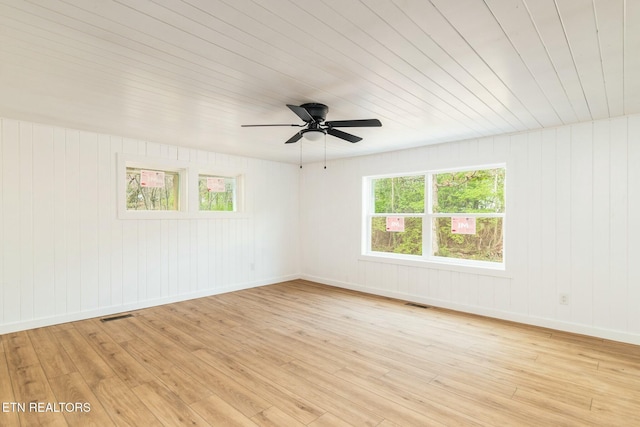 empty room with baseboards, visible vents, light wood-style flooring, and a ceiling fan