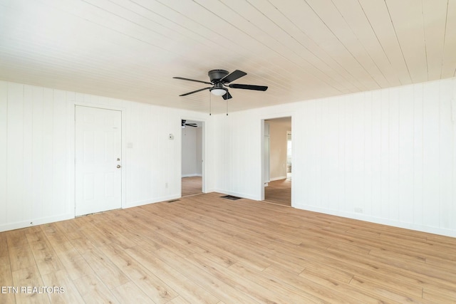 spare room featuring visible vents, baseboards, ceiling fan, and light wood-type flooring