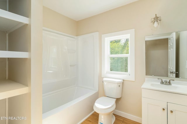 full bathroom with baseboards, bathtub / shower combination, toilet, wood finished floors, and vanity