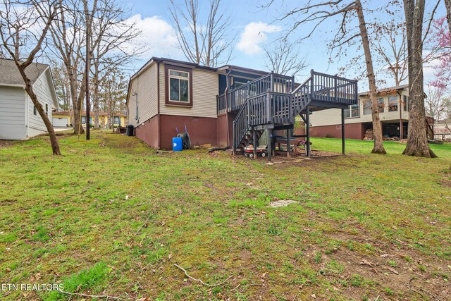 121 Lakeshire Dr, Crossville, TN 38558 - rear view of house featuring a deck, stairway, and a yard