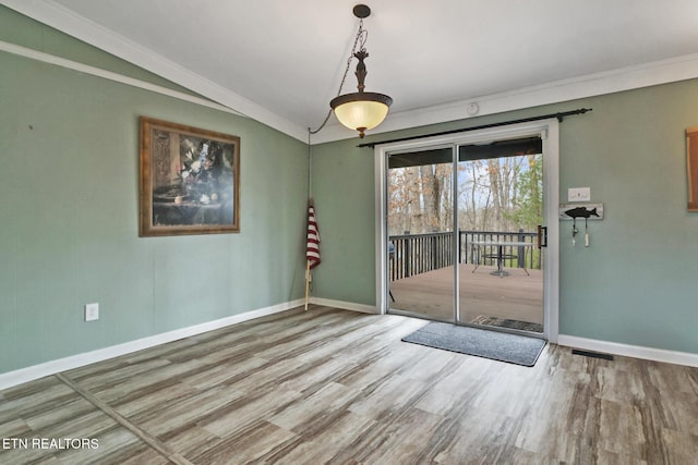 121 Lakeshire Dr, Crossville, TN 38558 - unfurnished dining area with crown molding, baseboards, vaulted ceiling, and wood finished floors