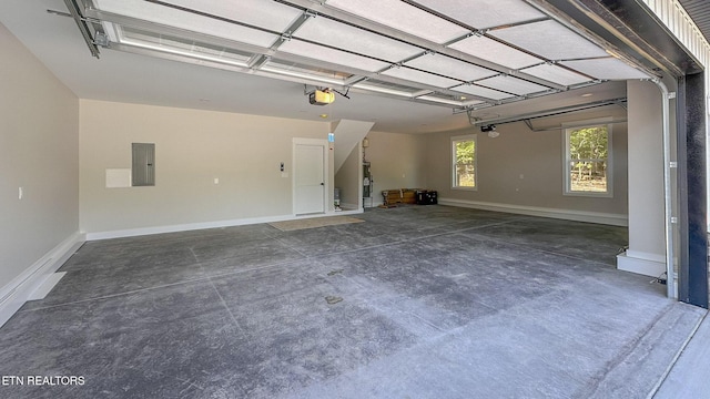 409 Goweli Trl, Vonore, TN 37885 - garage with electric panel, a garage door opener, baseboards, and water heater