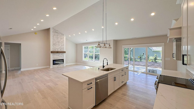 409 Goweli Trl, Vonore, TN 37885 - kitchen with a sink, stainless steel dishwasher, a fireplace, light wood-type flooring, and high vaulted ceiling
