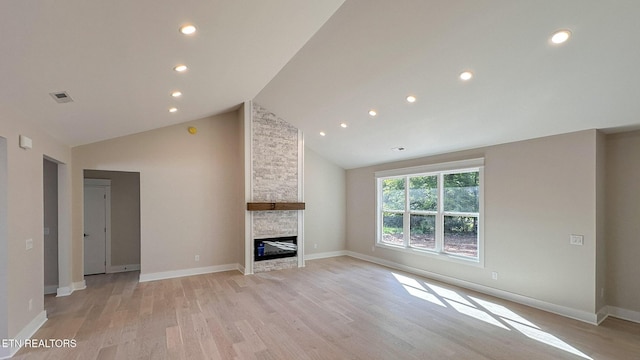 409 Goweli Trl, Vonore, TN 37885 - unfurnished living room with light wood-type flooring, recessed lighting, baseboards, a fireplace, and high vaulted ceiling