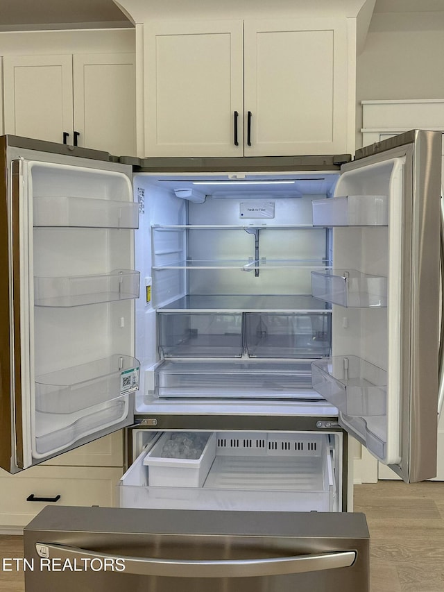 409 Goweli Trl, Vonore, TN 37885 - kitchen view of light wood-style flooring and fridge