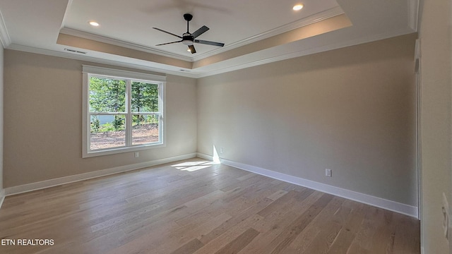409 Goweli Trl, Vonore, TN 37885 - spare room with a raised ceiling, crown molding, light wood-style flooring, ceiling fan, and baseboards