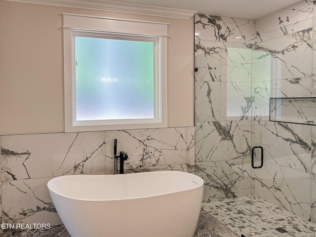 409 Goweli Trl, Vonore, TN 37885 - bathroom with tile walls, a marble finish shower, a soaking tub, crown molding, and marble finish flooring