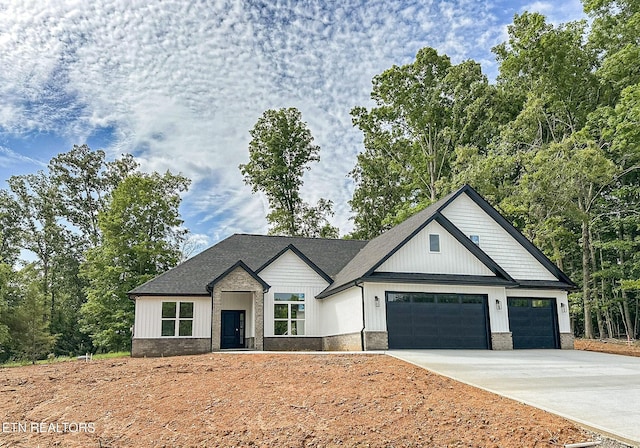 409 Goweli Trl, Vonore, TN 37885 - modern farmhouse featuring concrete driveway and a garage