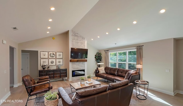 409 Goweli Trl, Vonore, TN 37885 - living area with a large fireplace, baseboards, high vaulted ceiling, recessed lighting, and light wood-type flooring