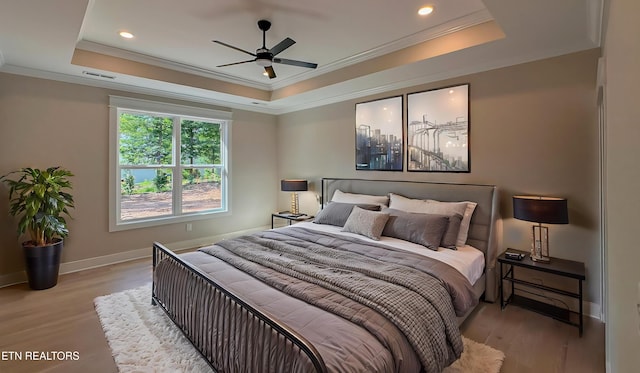 409 Goweli Trl, Vonore, TN 37885 - bedroom with a raised ceiling, ornamental molding, light wood-style flooring, baseboards, and recessed lighting