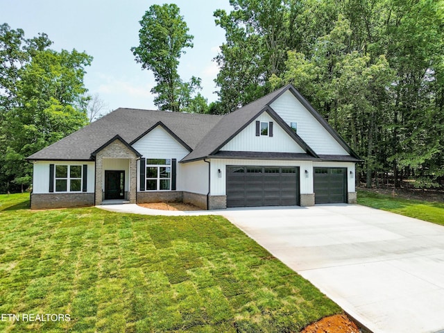 409 Goweli Trl, Vonore, TN 37885 - modern farmhouse style home with concrete driveway, a garage, and a front lawn