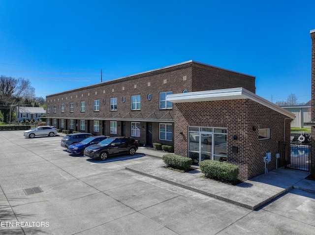 view of property with uncovered parking