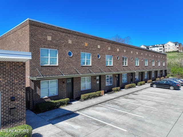 view of building exterior featuring uncovered parking