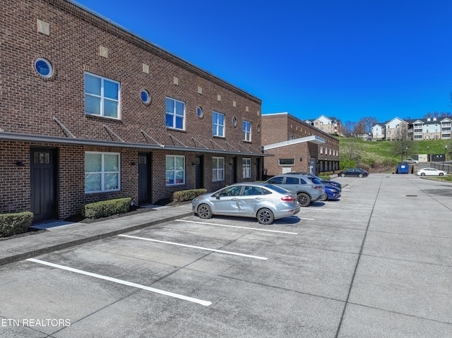 uncovered parking lot with a residential view