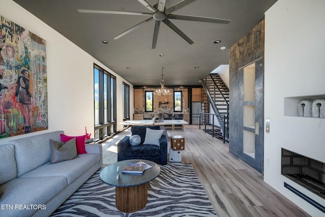210 Granite Dr, Sevierville, TN 37876 - living area featuring stairs, recessed lighting, ceiling fan with notable chandelier, and light wood finished floors