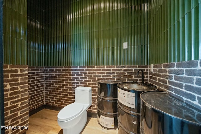 210 Granite Dr, Sevierville, TN 37876 - bathroom featuring toilet, vanity, and brick wall