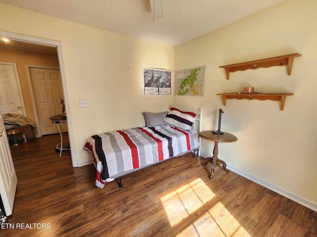 bedroom featuring baseboards and wood finished floors