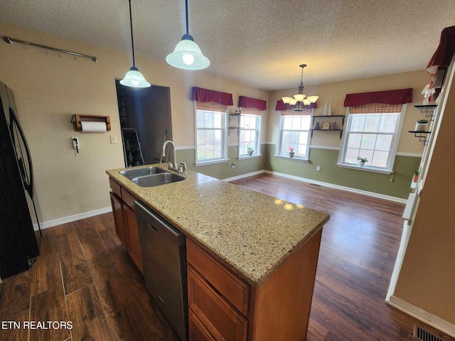 kitchen featuring a sink, dishwasher, dark wood finished floors, brown cabinets, and fridge