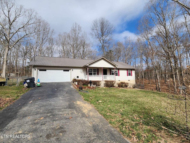 ranch-style house with fence, an attached garage, a front lawn, driveway, and a porch