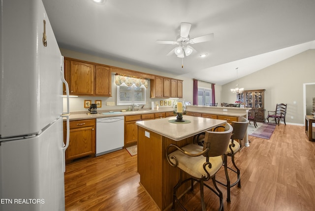118 Windsor Rd, Crossville, TN 38558 - kitchen featuring light countertops, vaulted ceiling, light wood-type flooring, white appliances, and a peninsula