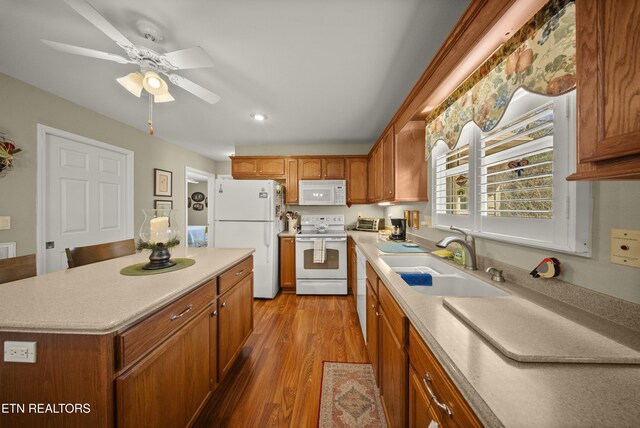 118 Windsor Rd, Crossville, TN 38558 - kitchen featuring light countertops, a sink, wood finished floors, brown cabinets, and white appliances
