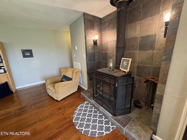 1347 Leffle Webb Rd, Crossville, TN 38572 - living area with baseboards, wood finished floors, and a wood stove