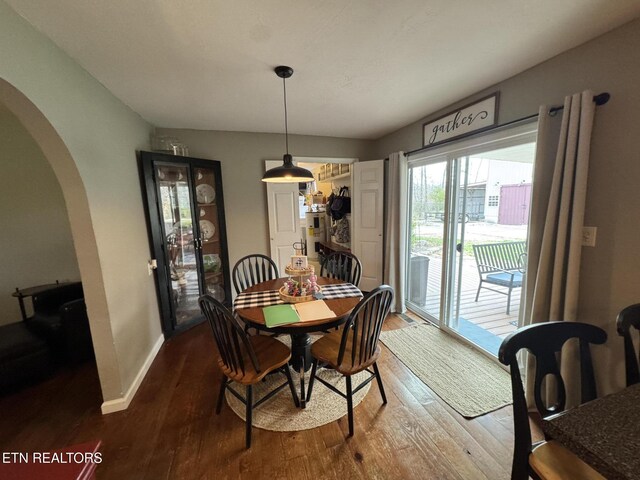 1347 Leffle Webb Rd, Crossville, TN 38572 - dining area with arched walkways, dark wood-style floors, and baseboards